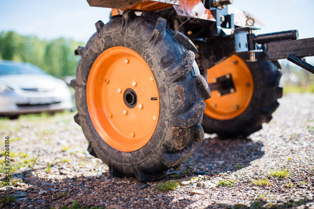 Large dump truck wheels on the ground. tractor wheel close-up. Large dump truck wheels on the ground. tractor wheel close-up.