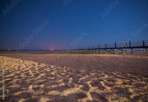 summer night scenic on sendy beach and long pantone to the sea photo