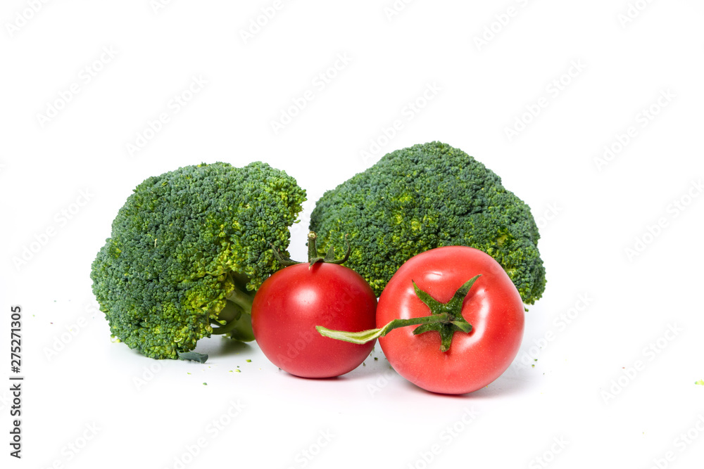 fresh broccoli and tomatoes isolated on white background