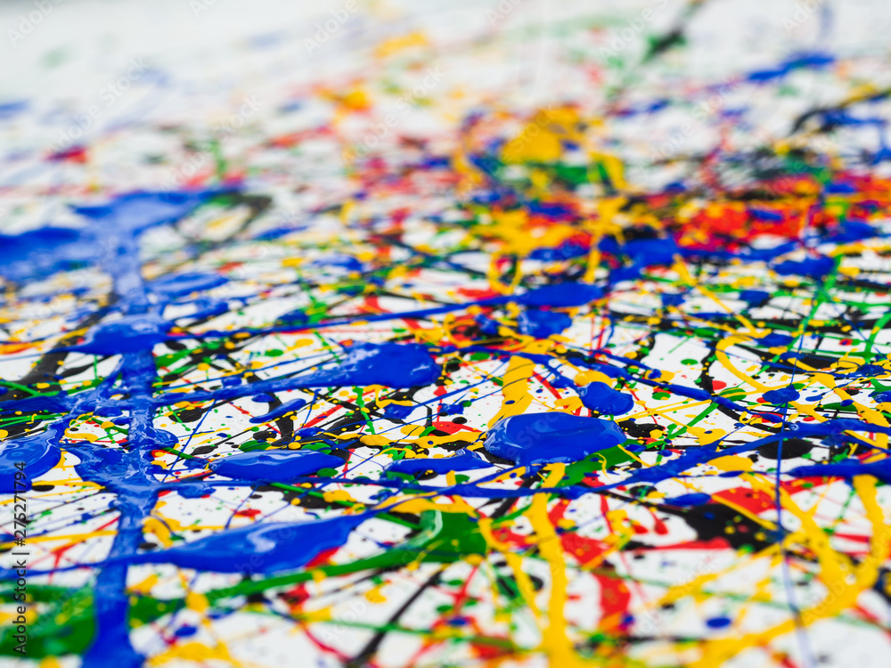 Fototapeta premium Abstract expressionism art creative background. art of splashes and drips . red black green yellow blue paint on white background.