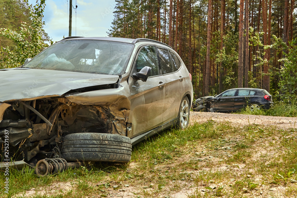 Car accident on country road in the middle of forest in June