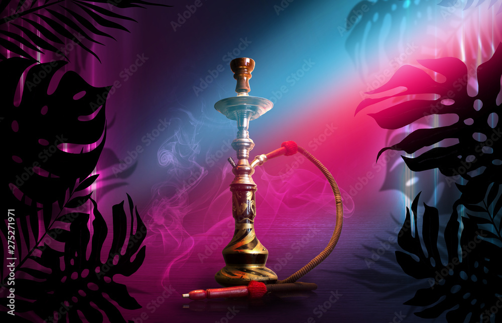 Smoking hookah on a dark abstract background, neon light. Silhouettes of tropical palm leaves in the foreground. Smoking hookah on a dark abstract background, neon light. Silhouettes of tropical palm leaves in the foreground.