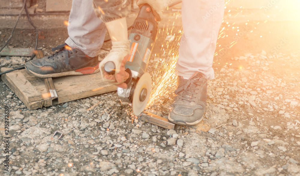 Worker in overalls and a protective mask cuts metal apparatus. The profession of welder. The man in overalls. worker cutting metal with a saw. grinder. Worker in overalls and a protective mask cuts metal apparatus. The profession of welder. The man in overalls. worker cutting metal with a saw. grinder.