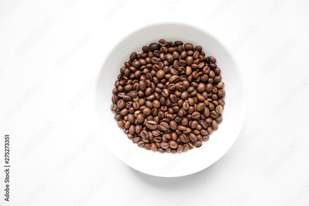 coffee beans brown closeup with blurred background in white plate on white isolated background coffee beans brown closeup with blurred background in white plate on white isolated background
