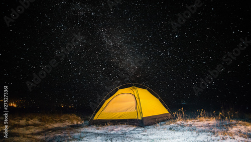 Camping for a starry night. The tent glows under the night sky full of stars. Milky Way. leisure tourists. for friends