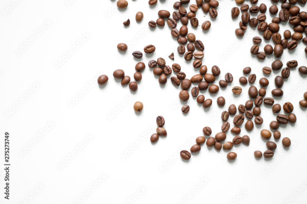 brown coffee grains on a white isolated background with space top view brown coffee grains on a white isolated background with space top view