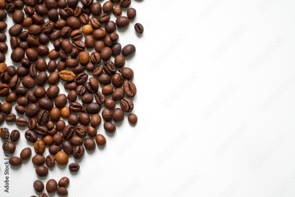 brown coffee grains on a white isolated background with space top view brown coffee grains on a white isolated background with space top view