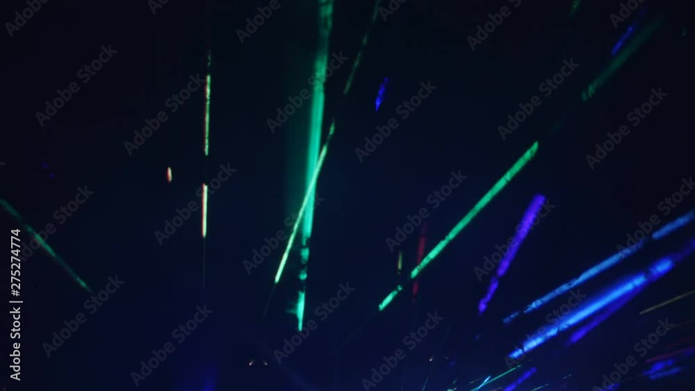 Laser show in a under the open sky. Laser beams and strobe lights in the night sky
