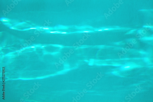 Trendy blue colored abstract background with light and shadows caustic effect. Light passes through a glass.