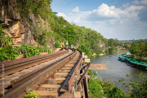 Kanchanaburi, Thailand, May 5, 2019 - Tourists walking on the Death railway on vacation
