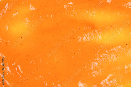 Orange sauce splashes isolated on white background photo