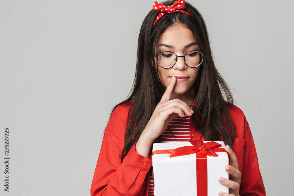 Fototapeta premium Cute wondering teenage girl wearing casual outfit