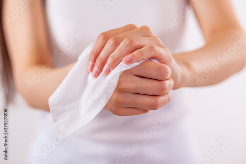 Close-up scene: woman cleaning hands with wet wipes