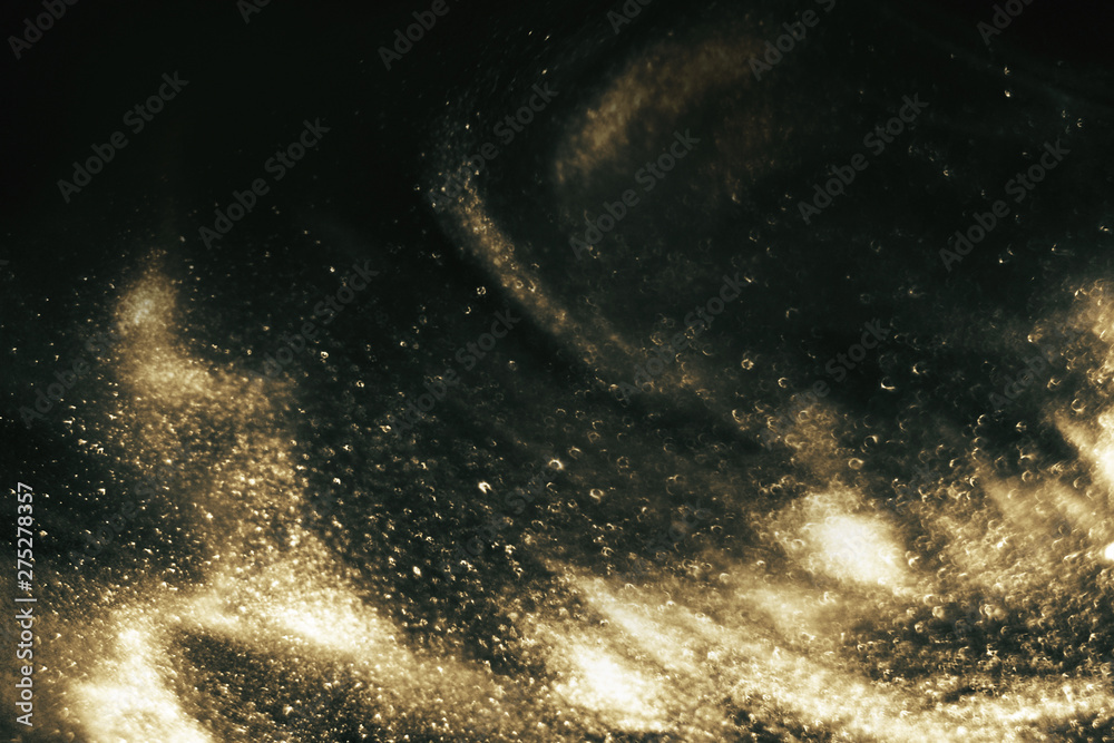 Fototapeta premium Abstract black and gold festive glitter shimmering magic luxury background. de-focused