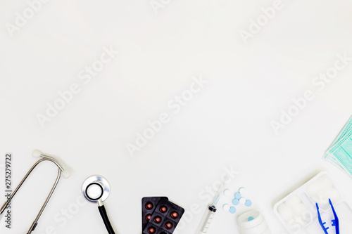 Stethoscope, Top view of doctor's desk table, blank paper on white background, above view doctor work tools on white, Stethoscope, laptop, eyeglass and medical drug on white background,,