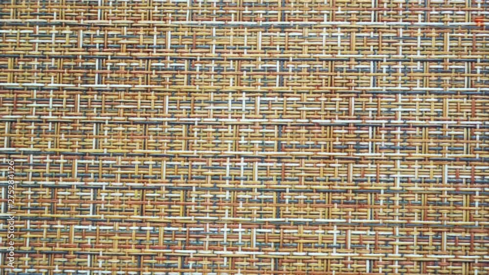 The texture of the fabric. Beige wicker fabric. Close-up. Can be used as a background. The texture of the fabric. Beige wicker fabric. Close-up. Can be used as a background.