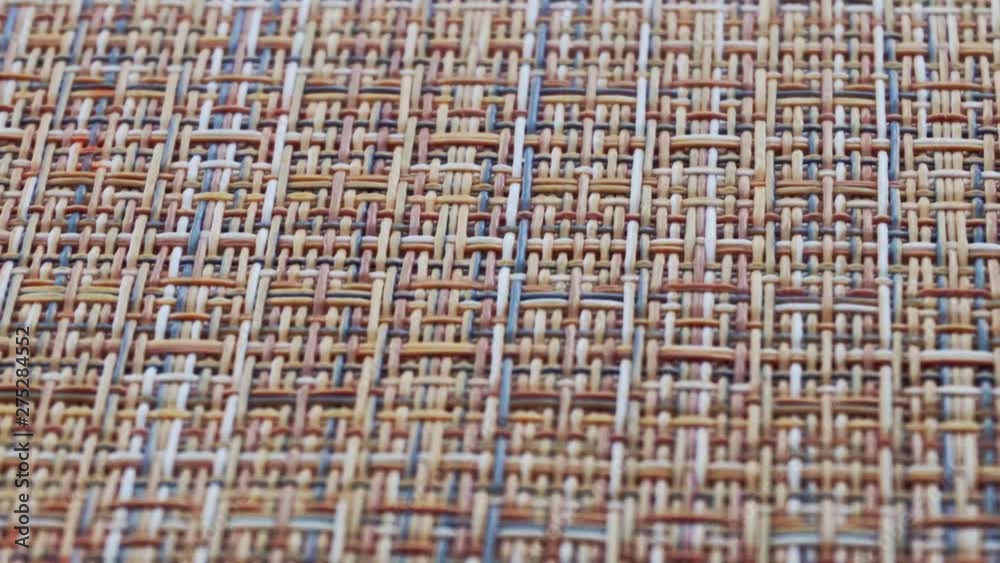The texture of the fabric. Beige wicker fabric. Close-up. Can be used as a background. The texture of the fabric. Beige wicker fabric. Close-up. Can be used as a background.