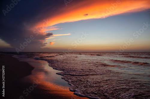 Beautiful panoramic view of the sandy beach during a dramatic cloudy sunset. Taken in Varadero, Cuba.