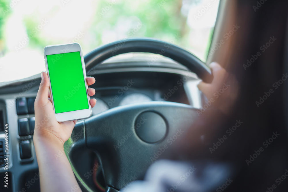 Smartphone are putting on the radio in a car.green scene