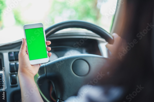 Smartphone are putting on the radio in a car.green scene © 2B
