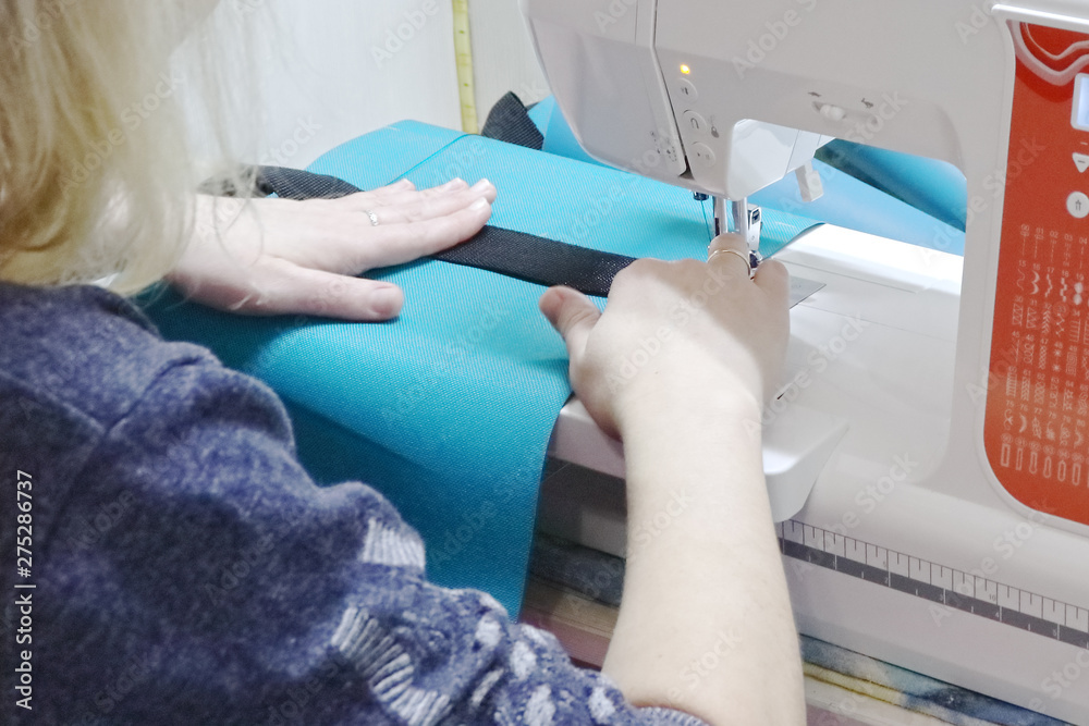Fototapeta premium Seamstress at work on a sewing machine.