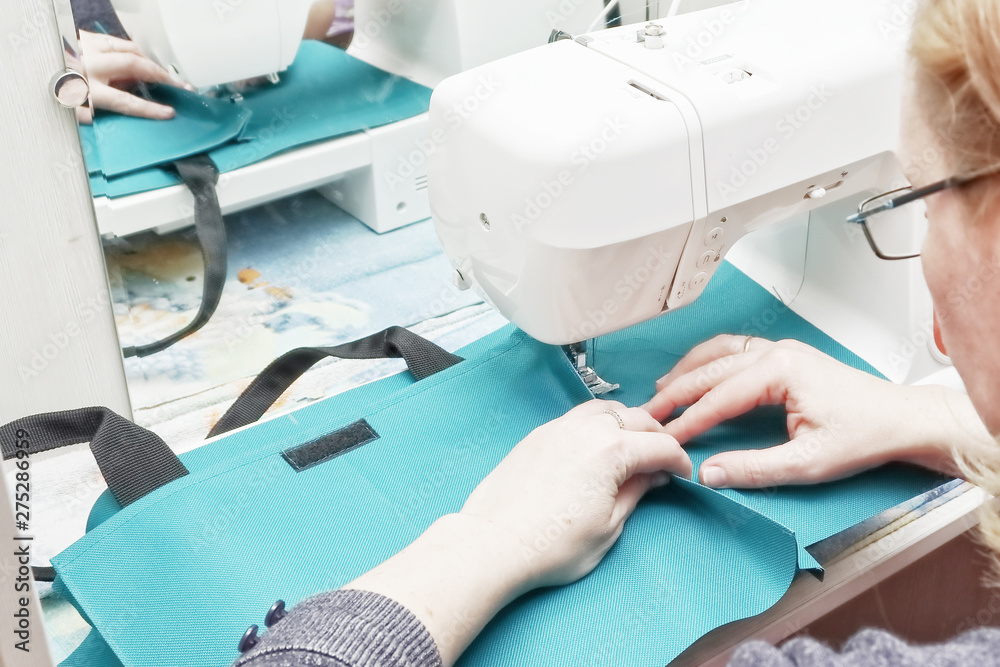 Seamstress at work on a sewing machine.