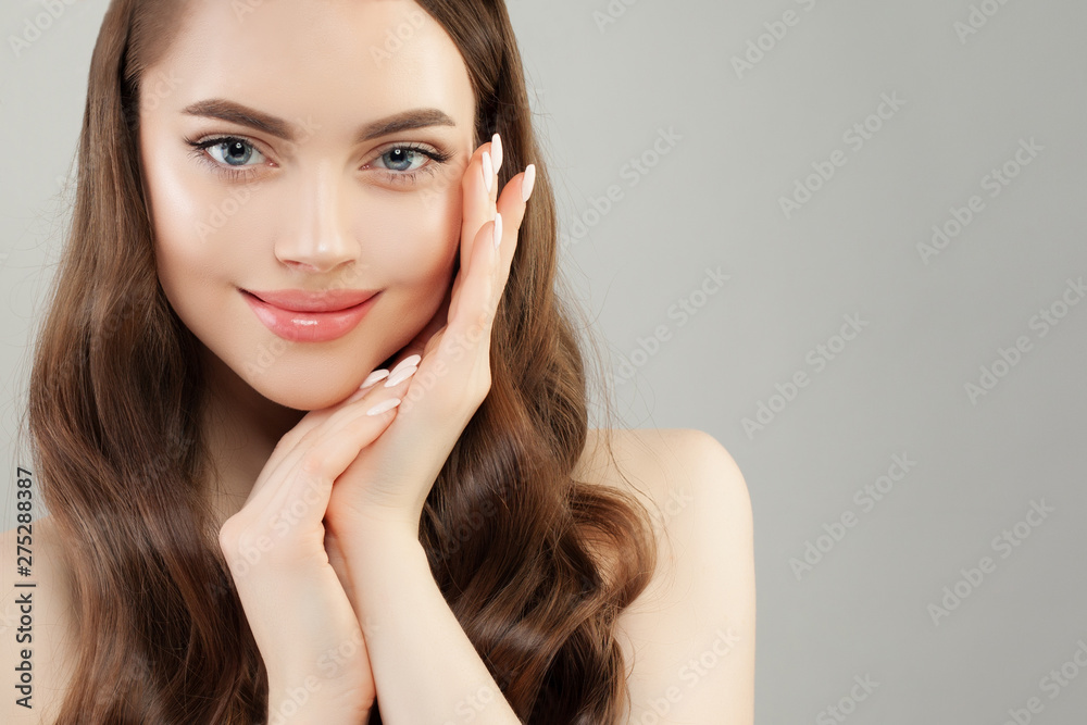 Spa model woman with clear skin and manicured nails on gray banner background Spa model woman with clear skin and manicured nails on gray banner background