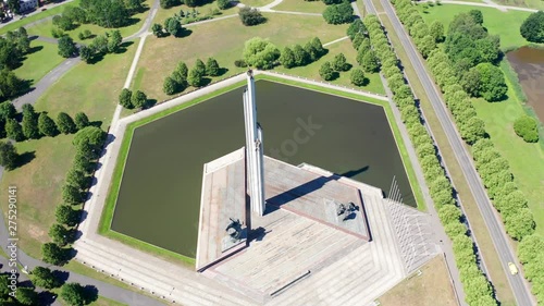 Circle Flight, Aerial View Of Victory Monument In Riga (Uzvaras Piemineklis), Water Reflecting Sun photo