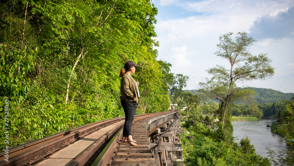 Asian female tourist standing on railway