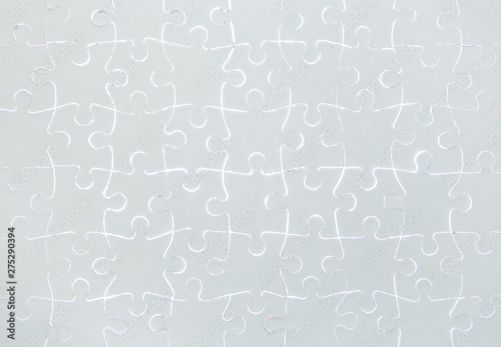 Blank white jigsaw puzzle pieces completed as copy space