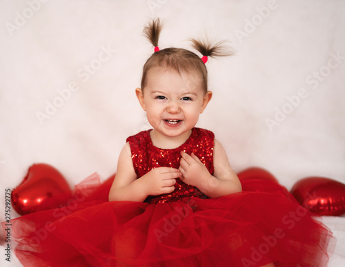 Smiling little girl in red dress