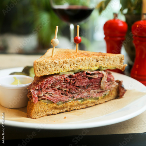 Pastrami sandwich with mustard and red wine