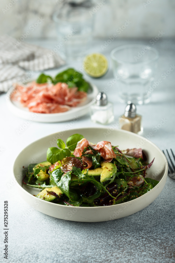 Healthy green salad with ham and avocado