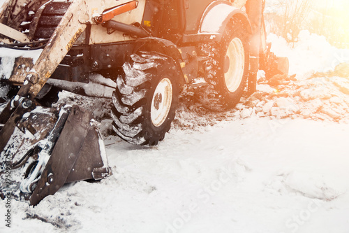 Wallpaper Mural digging the earth in winter. Tractor works on the construction site in the cold winter Construction and snow removal equipment at the plant - loader with snow unloading during roadworks Torontodigital.ca