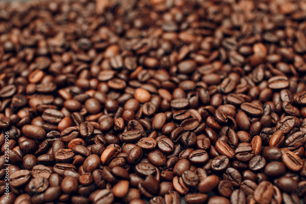 Roasted coffee beans brown seeds texture background wallpaper.