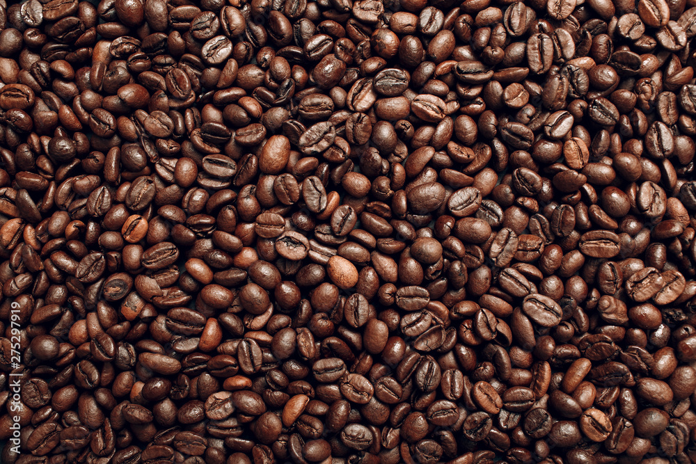 Roasted coffee beans brown seeds texture background wallpaper. Top view. Roasted coffee beans brown seeds texture background wallpaper. Top view.
