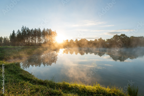 Morning fog on the forest lake.