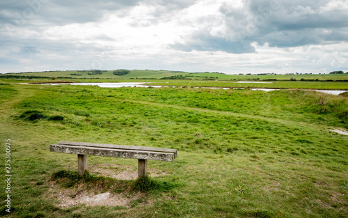 Bench with a view over the South Downs, England. The flood plains of Cuckmere Haven on the South Downs national park on the south coast of England.