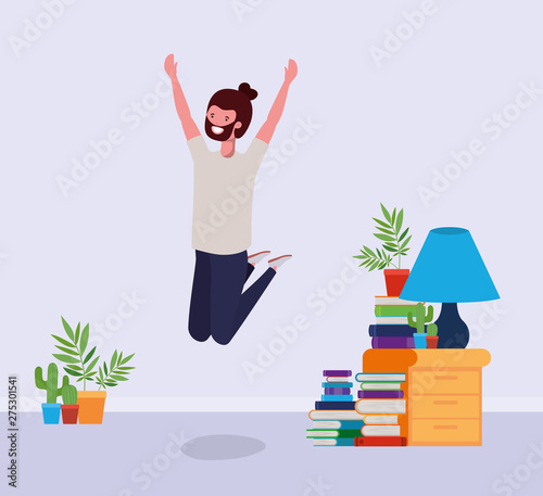 young man with beard jumping in the livingroom