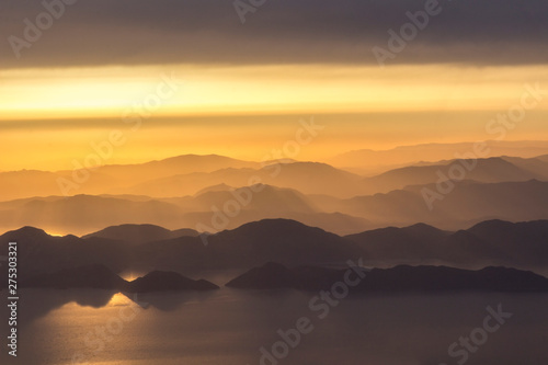 Mountains and the sea, sunset, sky in pastel colors, light haze, blur. © 201122