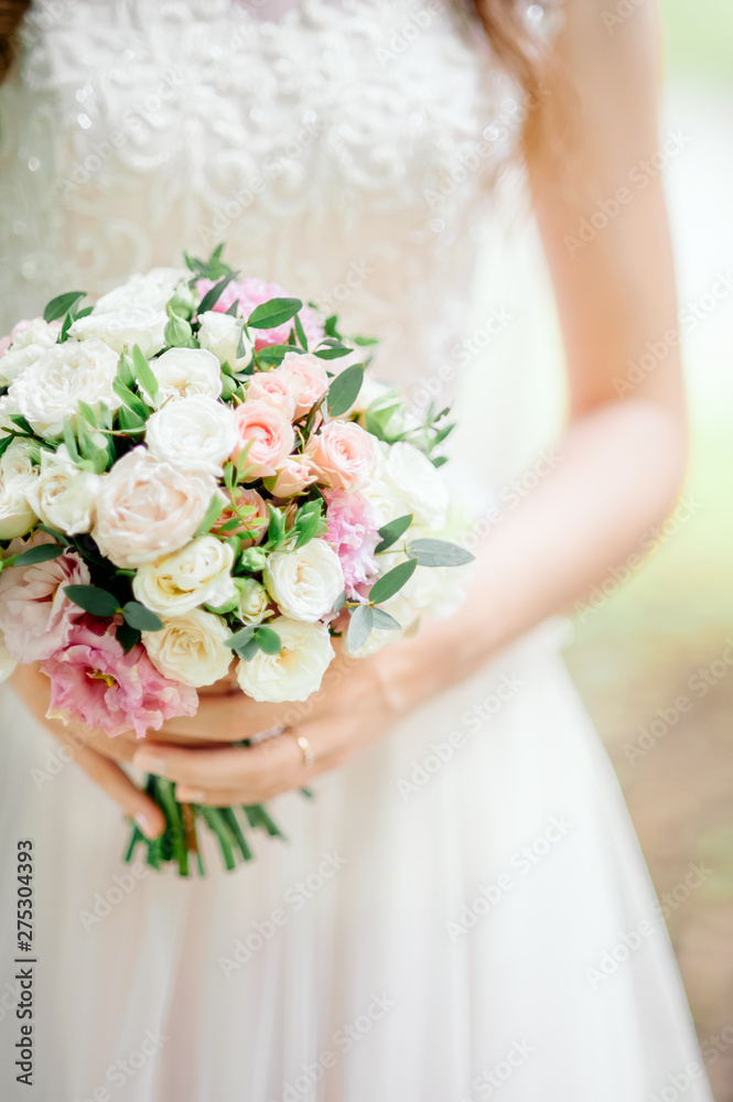 Diamond jewelry on a bridal bouquet.