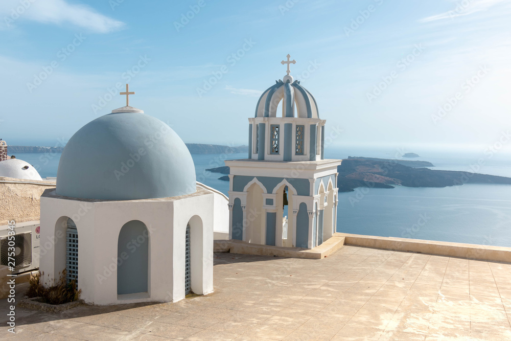 Church with blue dome by the ocean in Santorini