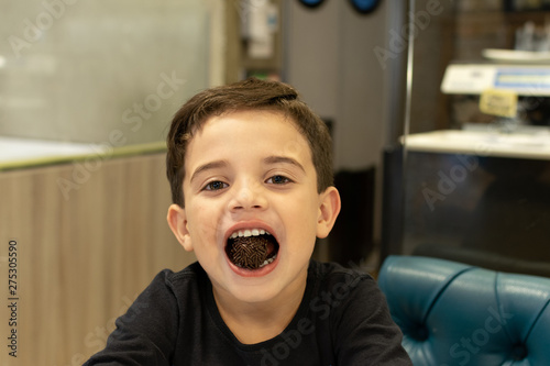 child with sweet brigadier in mouth in a Brazilian bakery pic2 photo