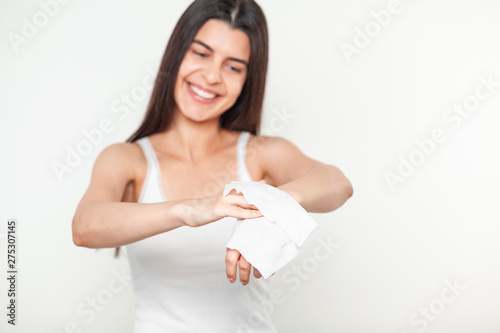 Beautiful young women cleaning hands with wet wipes photo