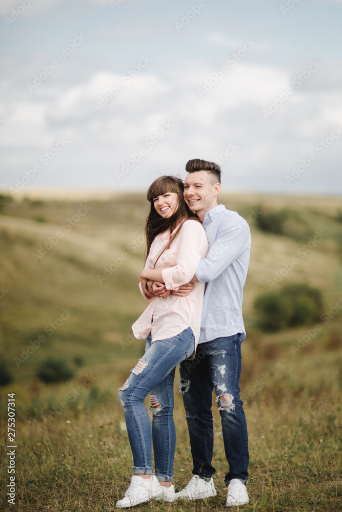 Happy young couple hugging and laughing outdoors. Love and tenderness. Lifestyle concept Happy young couple hugging and laughing outdoors. Love and tenderness. Lifestyle concept