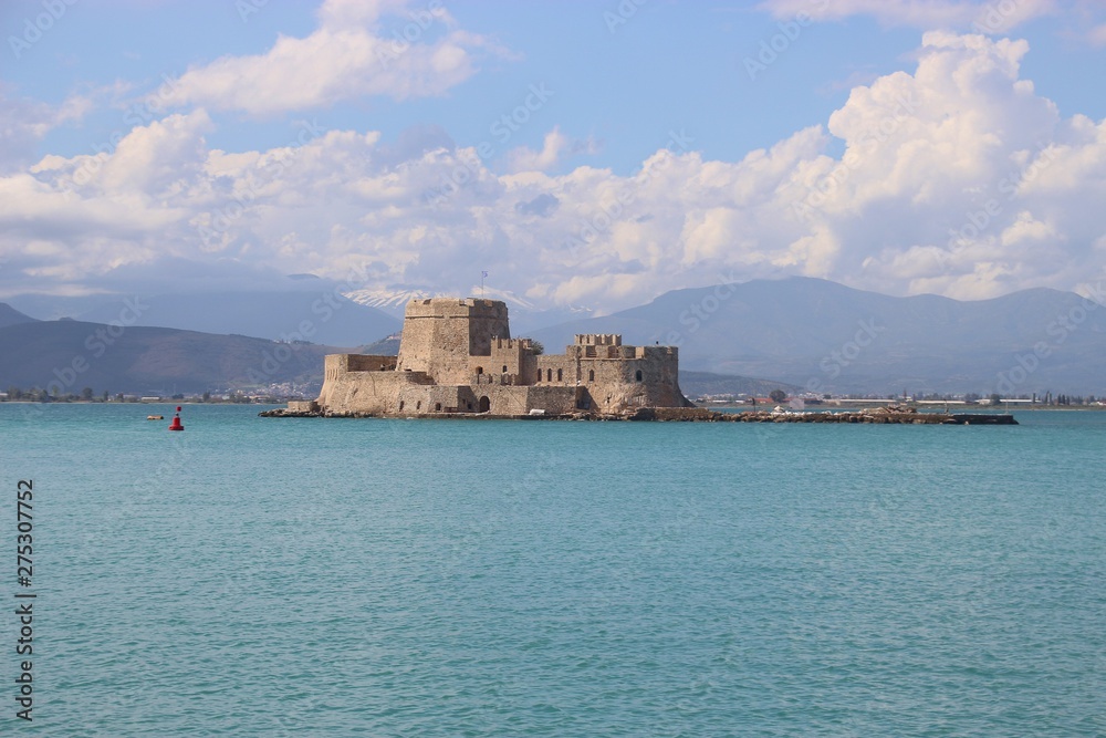 In the bay of Nafplio, Peloponnese, Greece. Bourtzi castle and mountain landscape. South-east Europe.