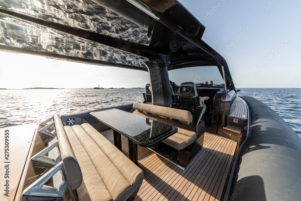 Fototapeta premium view on inflatable motor boat at sunset
