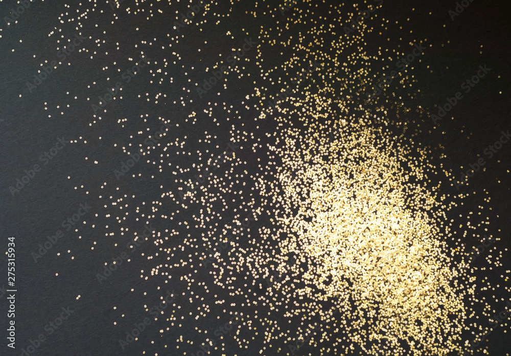 Black background with golden sparkles. Blurred  effect. Concept for festive background 