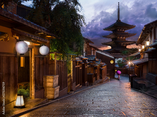 Woman in traditional dress on Kyoto street at sunset - purple kimono & umbrella	 photo