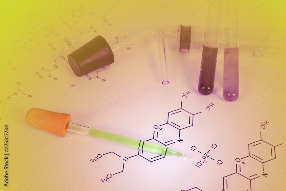 Laboratory test tube with dropper and chemical formula background , science concept. Laboratory test tube with dropper and chemical formula background , science concept.